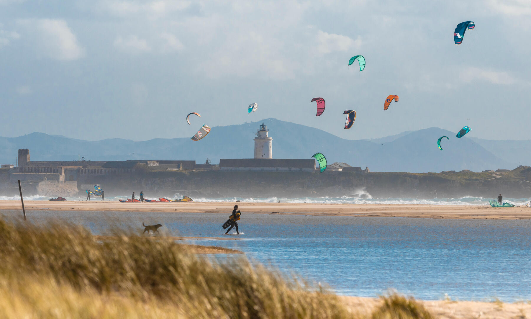 Find your ride. Anywhere the wind takes you. 🌍 Mobile screen showing COOMPI app for kite, wingfoil, surf and windsurf rentals in Tenerife and Tarifa. Travel light and rent gear at your destination.